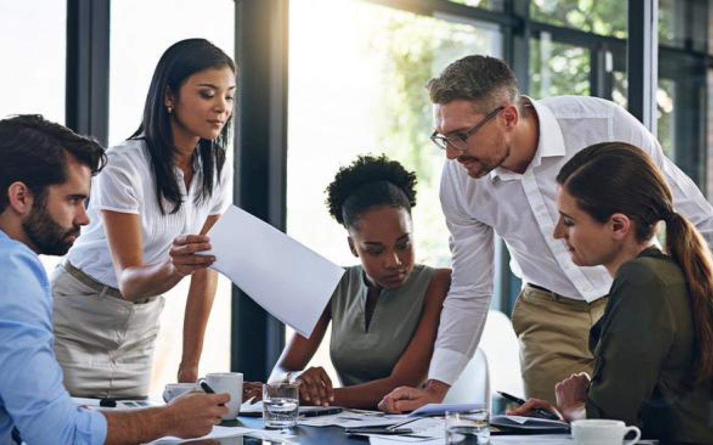 people discussing while sitting at a table