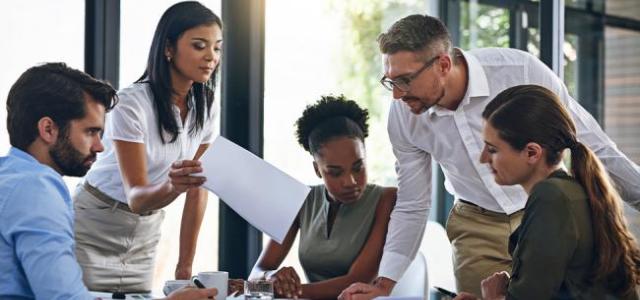 people discussing while sitting at a table